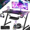 KESSER® Scrivania da Gioco LED - 120 x 60 cm, Scrivania a forma di Z, Gancio per Cuffie e Rivestimento in Carbonio, Scrivania Ergonomica per PC, con Portabicchieri, Nero Carbon