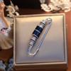 Spilla Argentato Trombone Incastonato Di Zirconia Cubica Asta Blu Art Deco Stile
