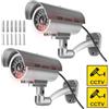 Sporgo 2 pezzi telecamera di sorveglianza: Dummy telecamera di sorveglianza esterna con luce a LED rossa lampeggiante, atrappe telecamera di sorveglianza finta fotocamera di sicurezza per interni ed